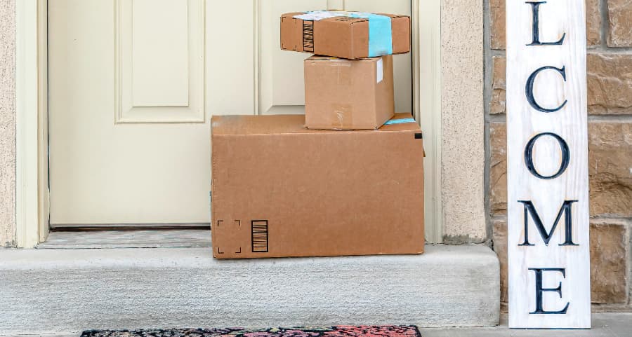 Packages on the doorstep of a home with a welcome sign in Springfield